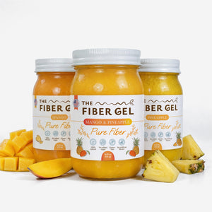 Three jars of 'The Fiber Gel' with mango and pineapple pieces on a white background